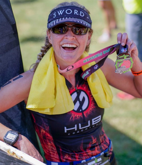 Team Hub member holding medal after race.